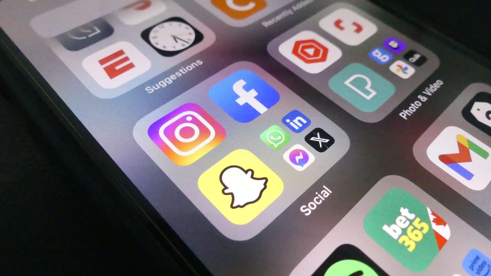 Close-up of a smartphone screen displaying popular social media app icons
